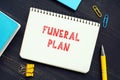 Financial concept about FUNERAL PLAN with sign on the piece of paper. AÃÂ Funeral PlanÃÂ is an easy way to pre-arrange the funeral